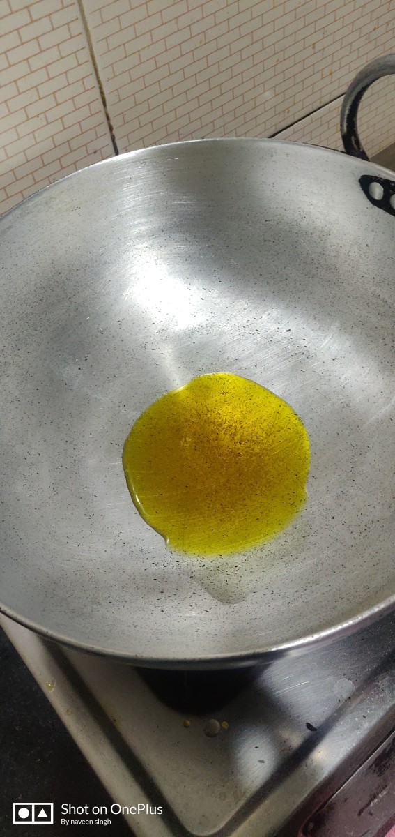 Pour mustard oil 50 ml in the cooking pot or frying pan & make it medium hot .