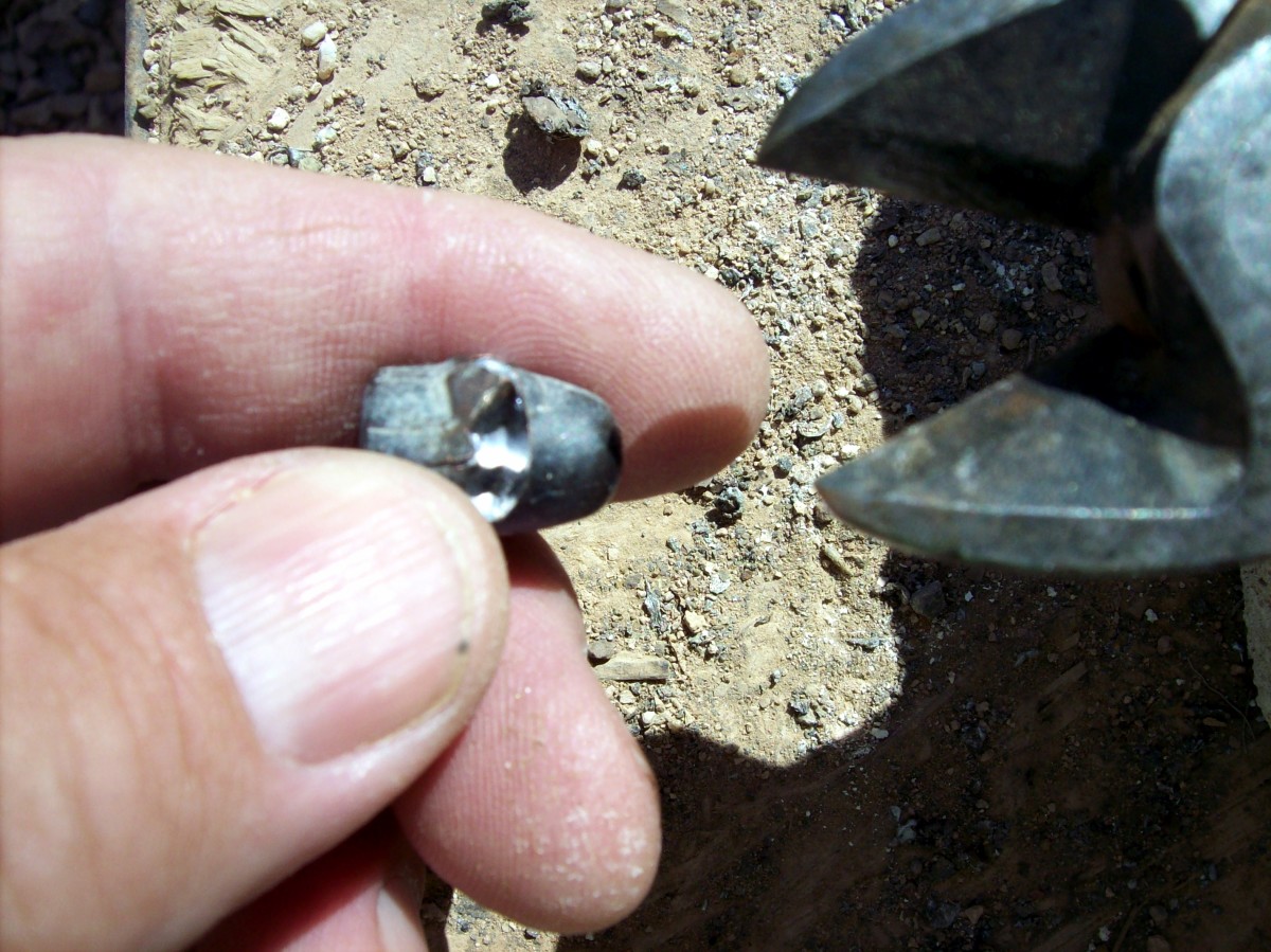 The metal jacket has been snipped by nippers. The shiny part is lead and when heated this bullet will release its lead into the crucible.