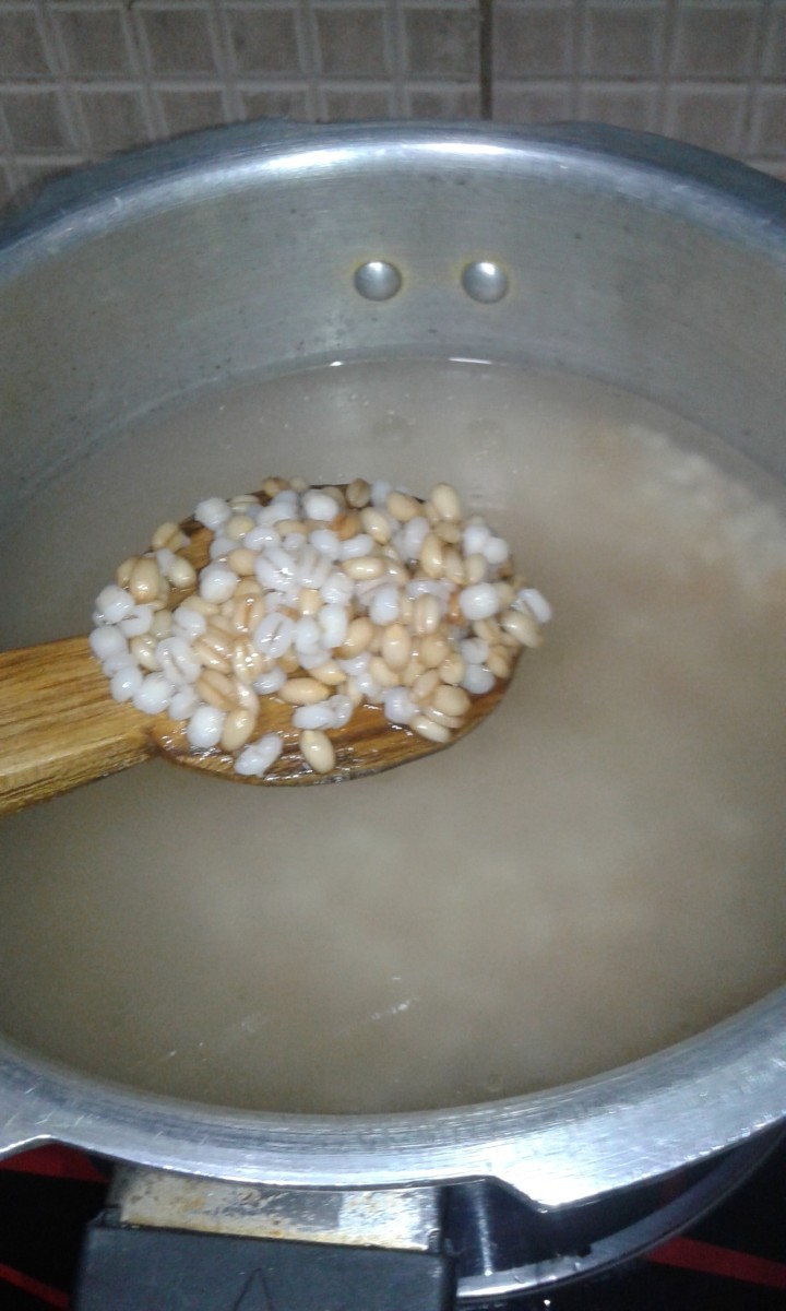 Add soaked wheat and barley in a pressure cooker with the same water.