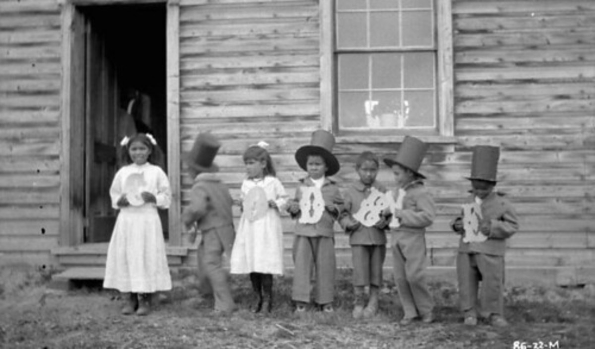 A rather sad little group of residential school children holding letters that spell “Goodbye.”