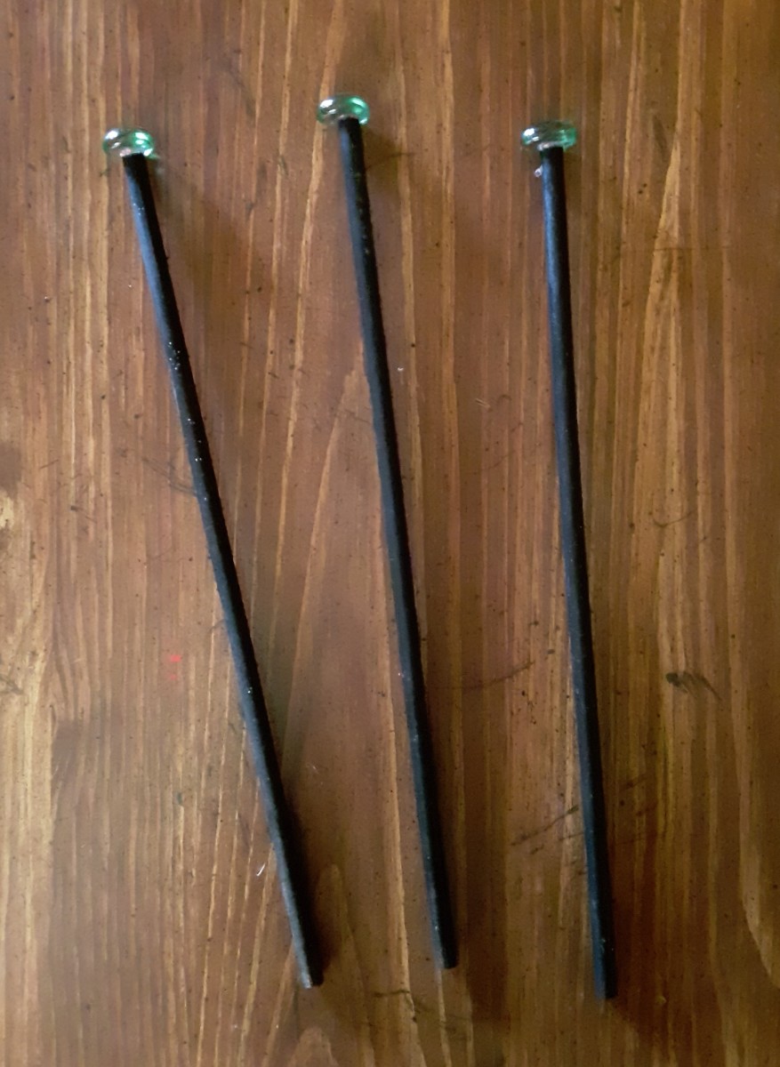 These are simpler wands. I painted the dowels black, and Hot glued gemstones on the tops.
