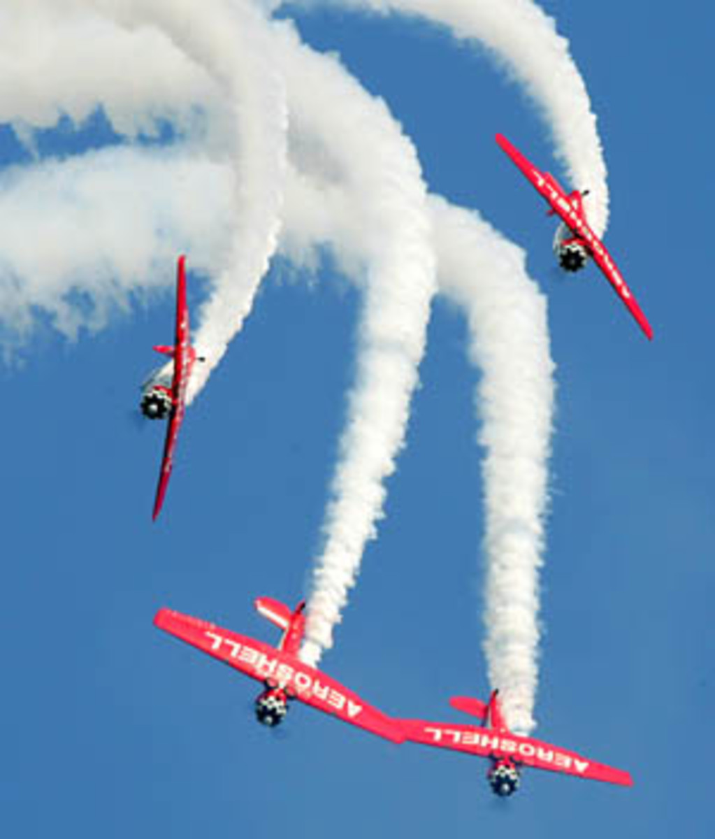 Red planes flying with white tail to promote eaa airventure Oshkosh Wisconsin