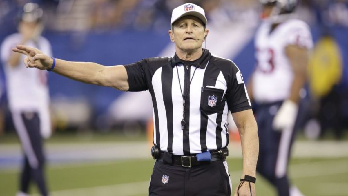 Head referee Ed Hochuli addresses a penalty during a game.