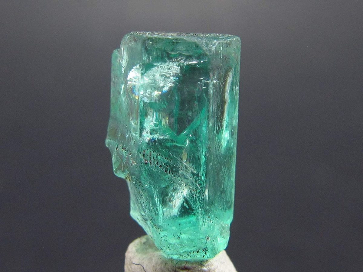 Beryl is  unique in that under natural lighting, it appears a bright green color, but in artificial lighting, it can have a reddish hue.