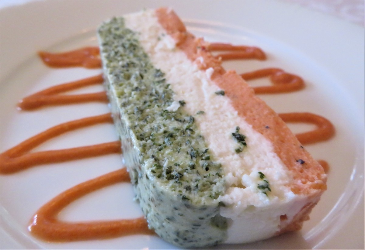 A slice of tricolor scallop terrine with a seafood sauce accompaniment 