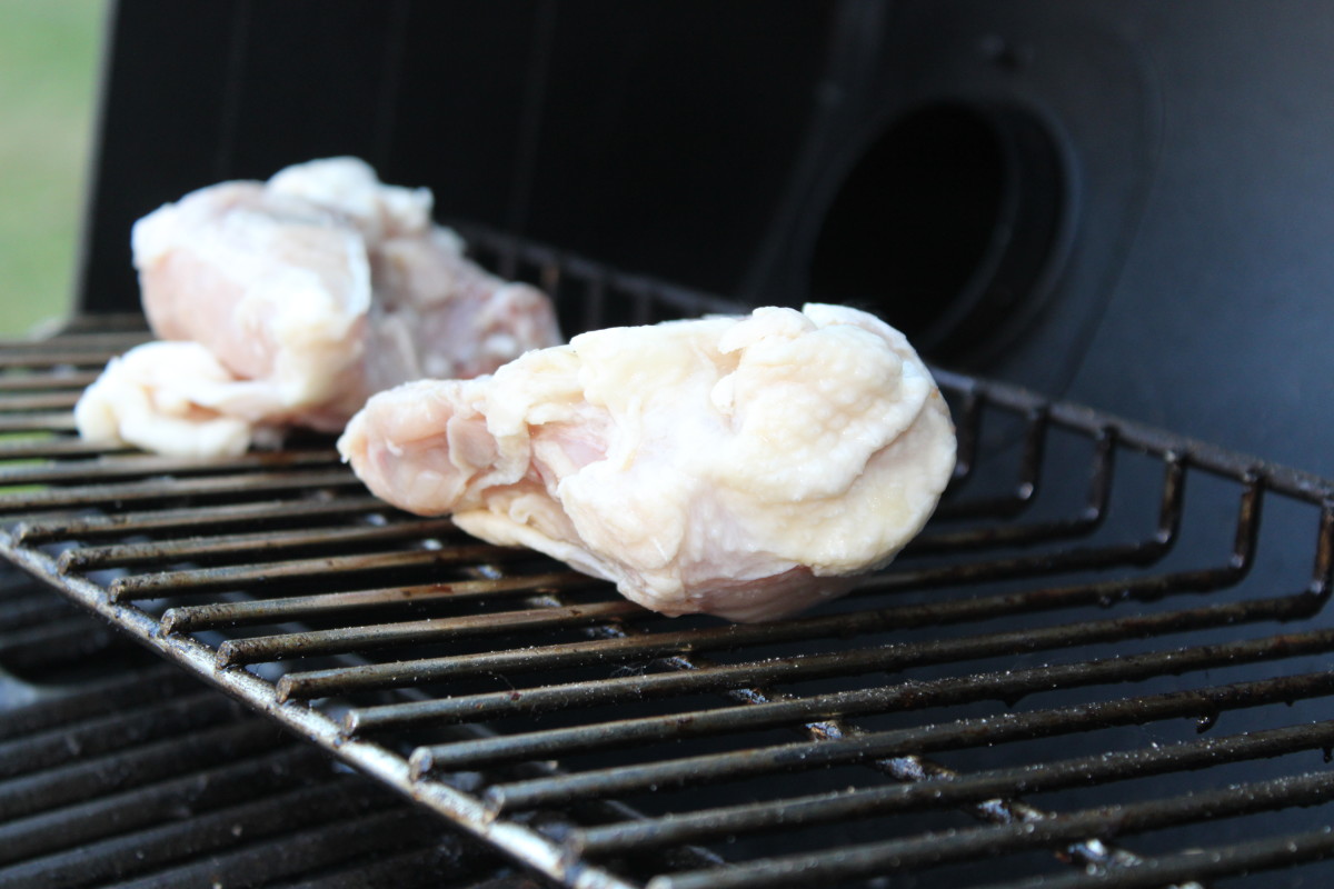 Start grilling your raw, frozen chicken breast in the top part of the Kingsford grill.