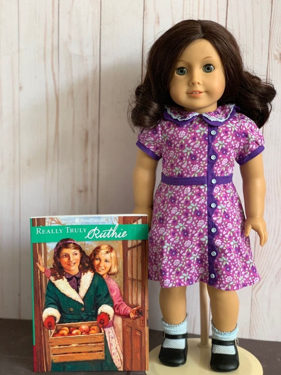 A Ruthie doll posed next to a Really Truly Ruthie book