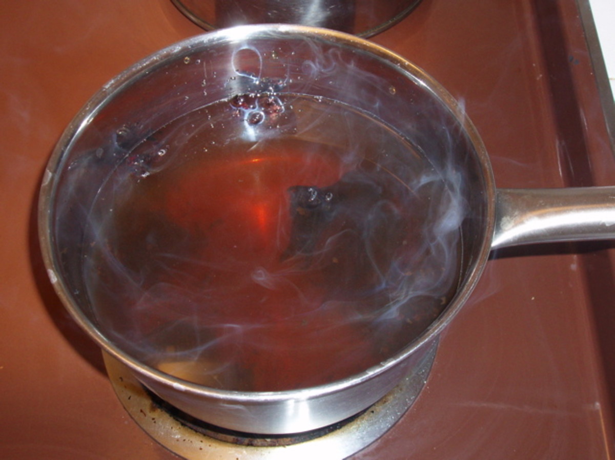 A pot of boiling water containing herbs - in this case rose hips, mint, and eucalyptus oil - makes a great DIY facial sauna. This is what I used to do, but it's kind of a hassle. 