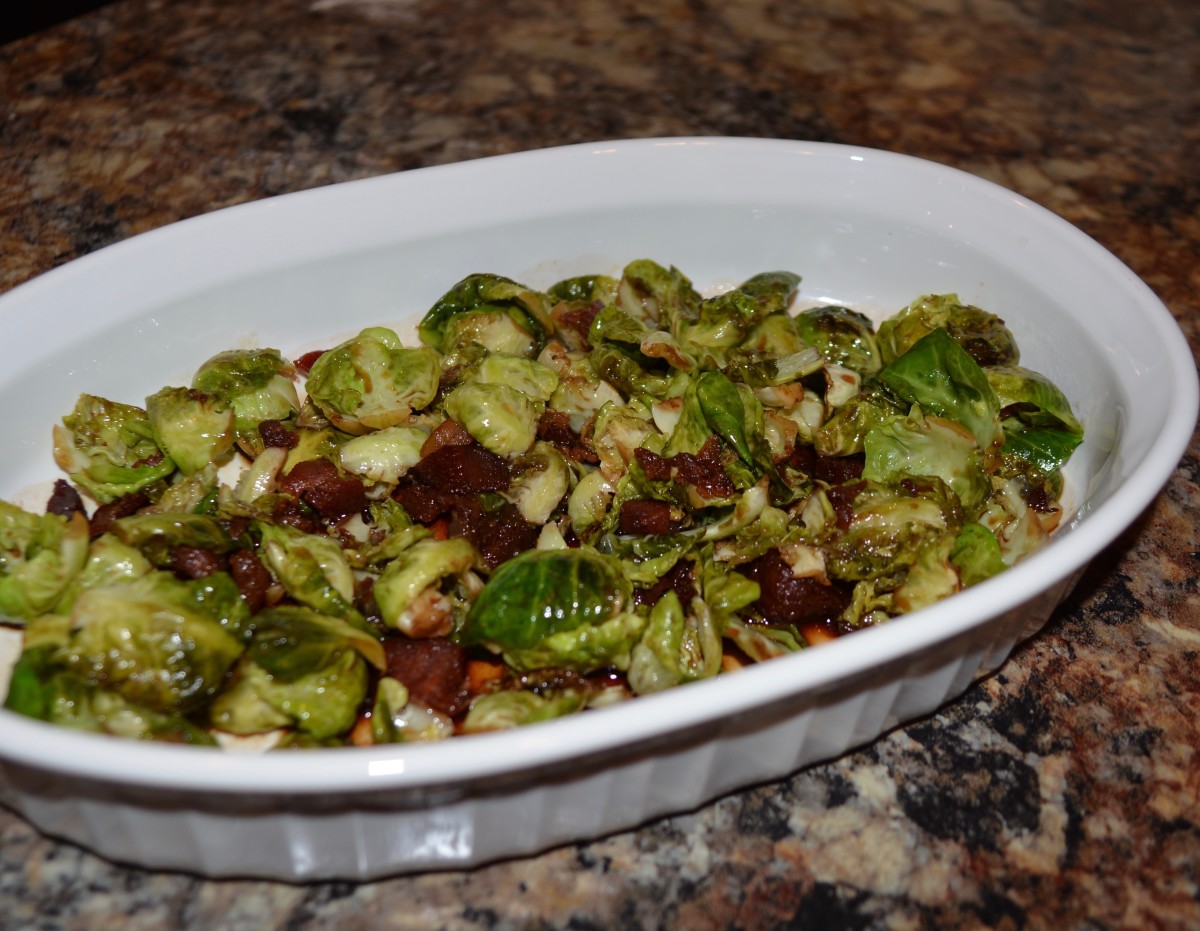 Leaves of Brussels sprouts steamed with bacon bits and pom seeds