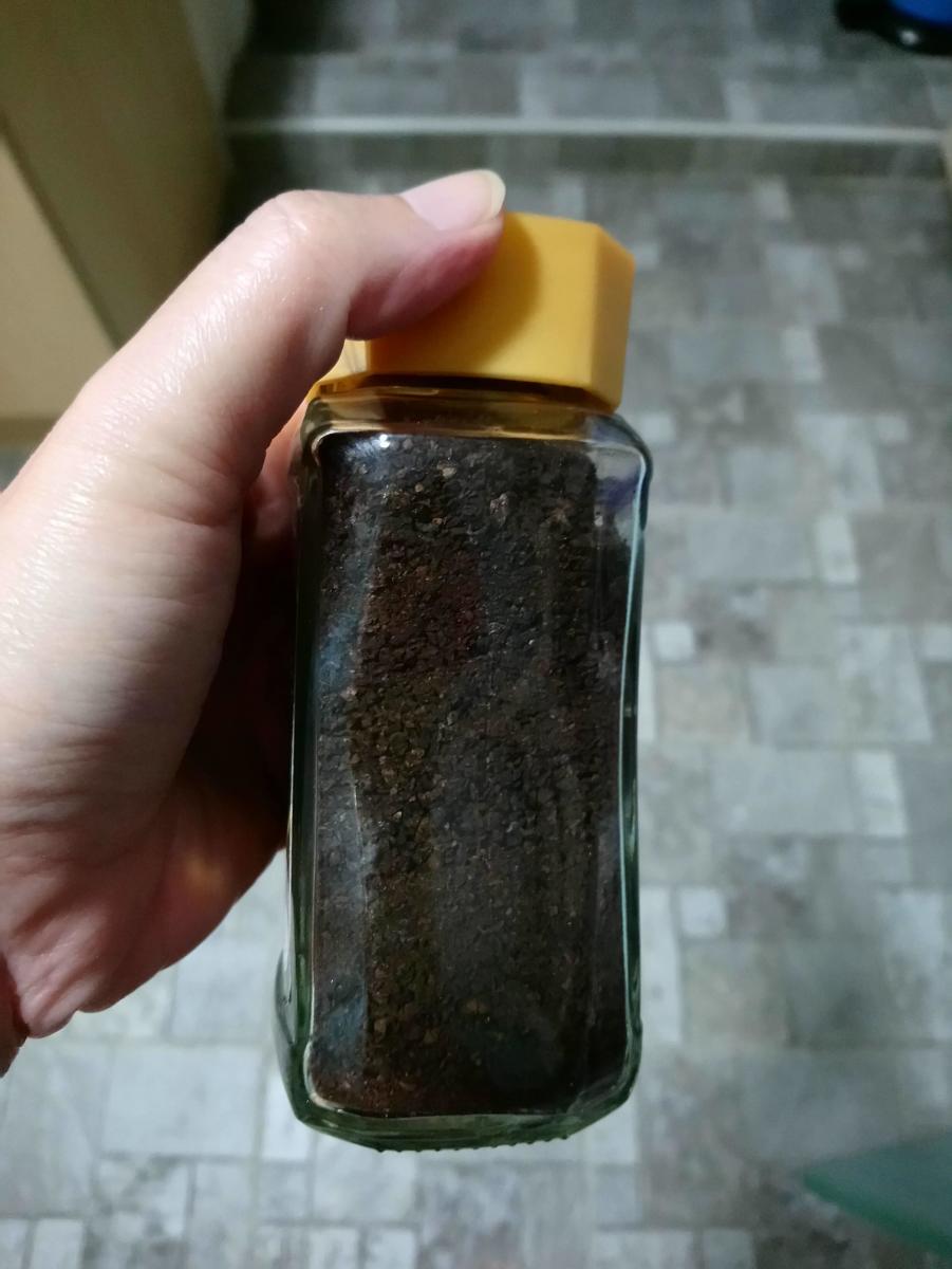 Storing loose dried coffee grounds in an airtight bottle.