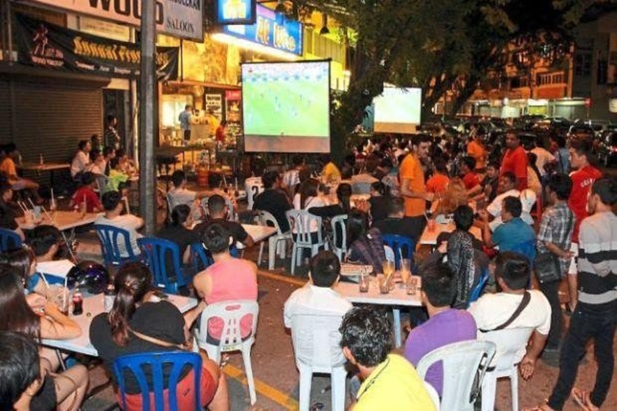 Malaysians hanging out at the Mamak store for a Football match