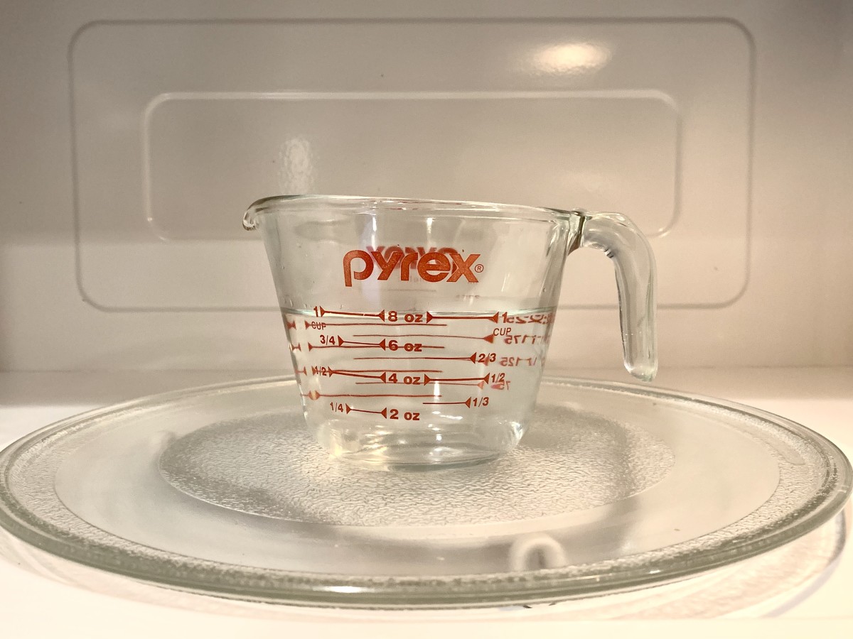 Heating up a 50:50 solution of white distilled vinegar and water will loosen dried splatters on the inside of the microwave.