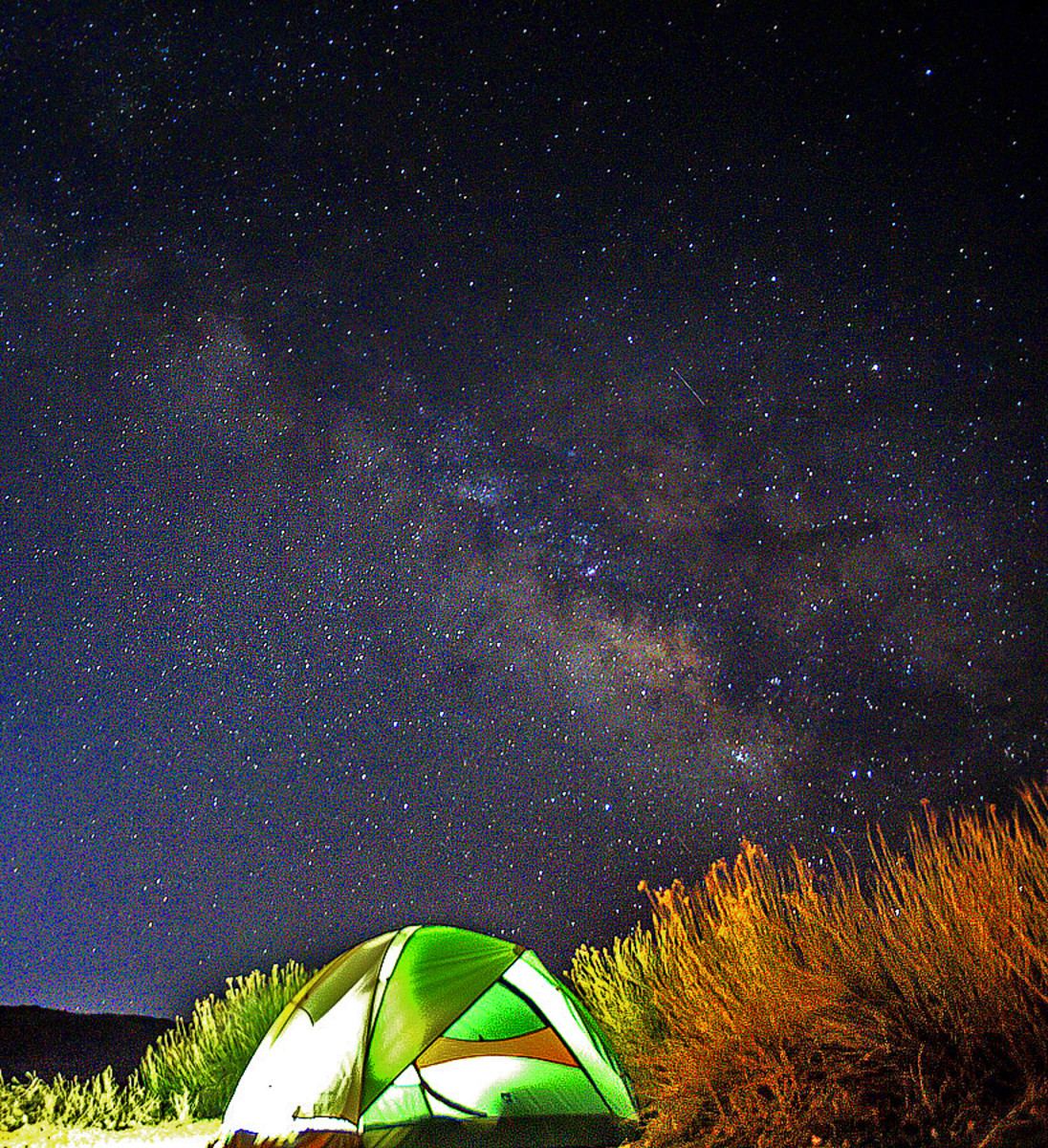 Camping under sparkling night sky.