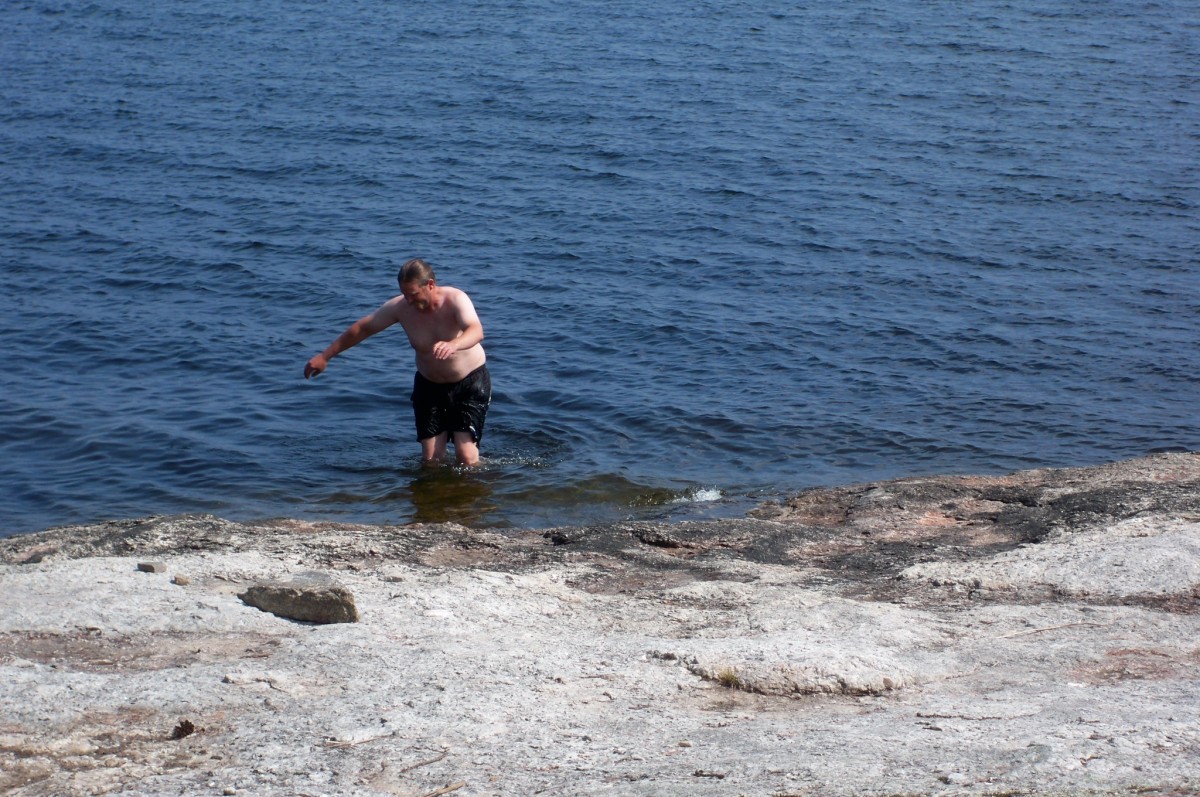 Steve tries to catch a fish with his bare hands on the shore of "our" island.