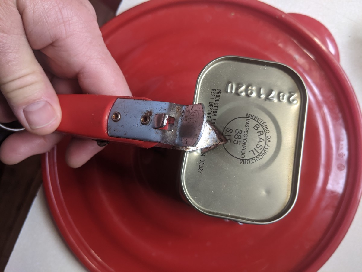 Reduce pressure in can with bottle opener. Then open with key.
