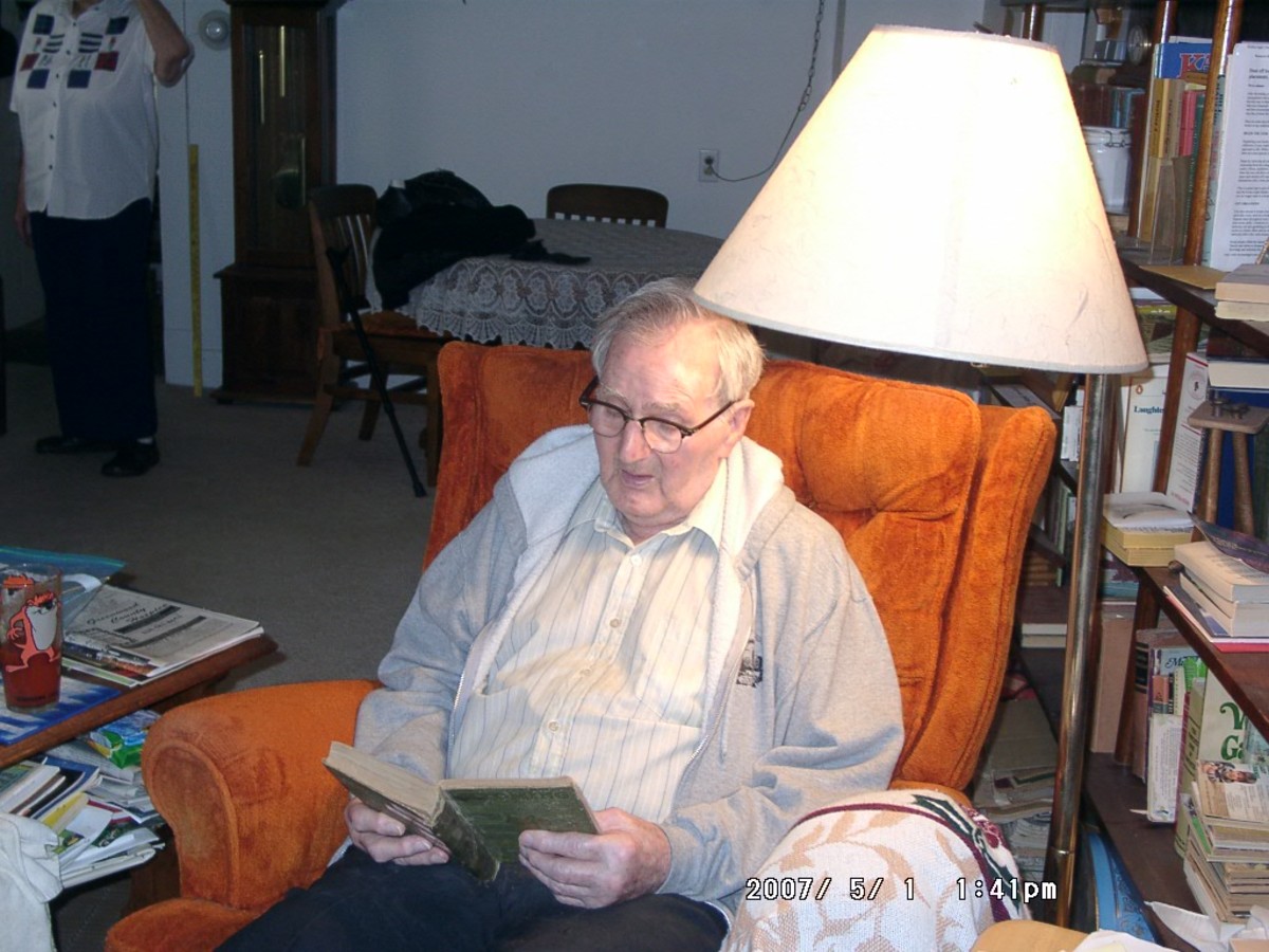 The lamp sheds plenty of light which older eyes need. A sweater or sweatshirt are his choice for keeping warm while reading. A table next to his chair gives him a place to keep his book at hand. 