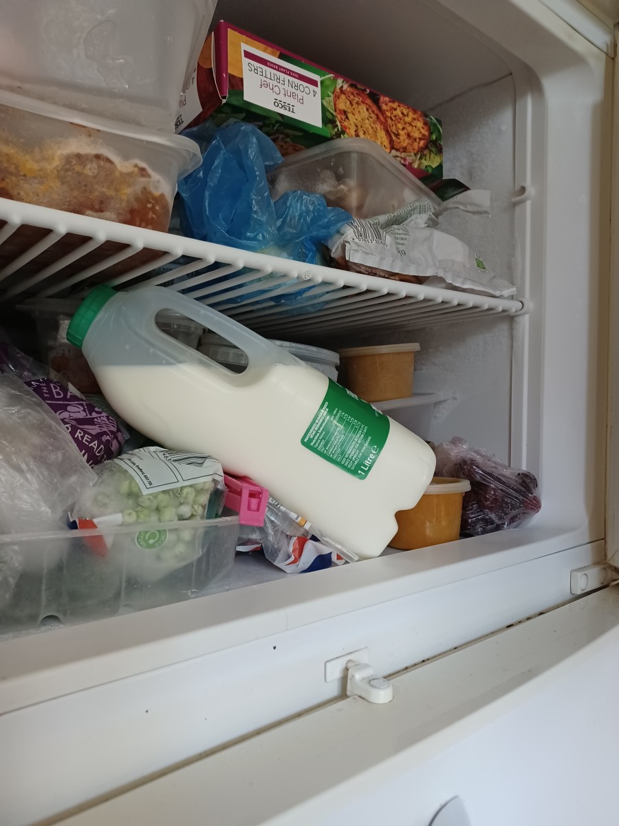 Once frozen, you can lay the milk on its side, so that it takes up less room