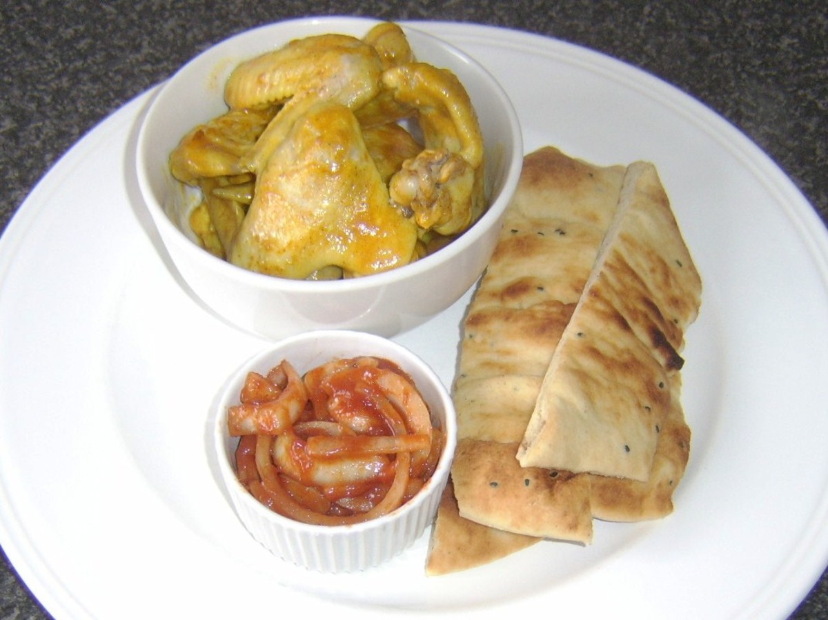 Chicken wings cooked in curry sauce, served with naan bread and Indian spiced onions