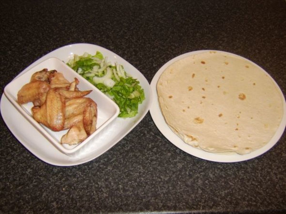 Roast chicken wings, simple salad and tortilla wrap