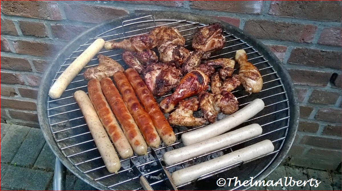 BBQ with chicken wings, chicken legs and sausages.