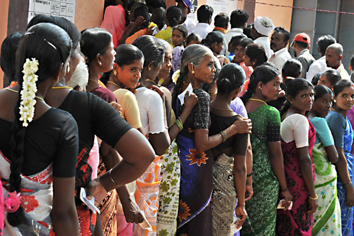 2009. Indian women queue to vote, each clutching their polling cards. India, despite its numerous historic problems of poverty, caste and religious division, has held together and is prospering - democratic stability in action