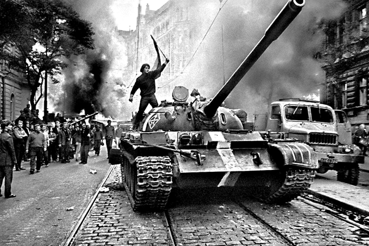 1968. Soviet tanks crush the Czechoslovakian bid for freedom from Communist oppression, as one young Czech bravely protests and clambers on to a Soviet tank and waves the national flag - an image with echoes in the Tiananmen photo