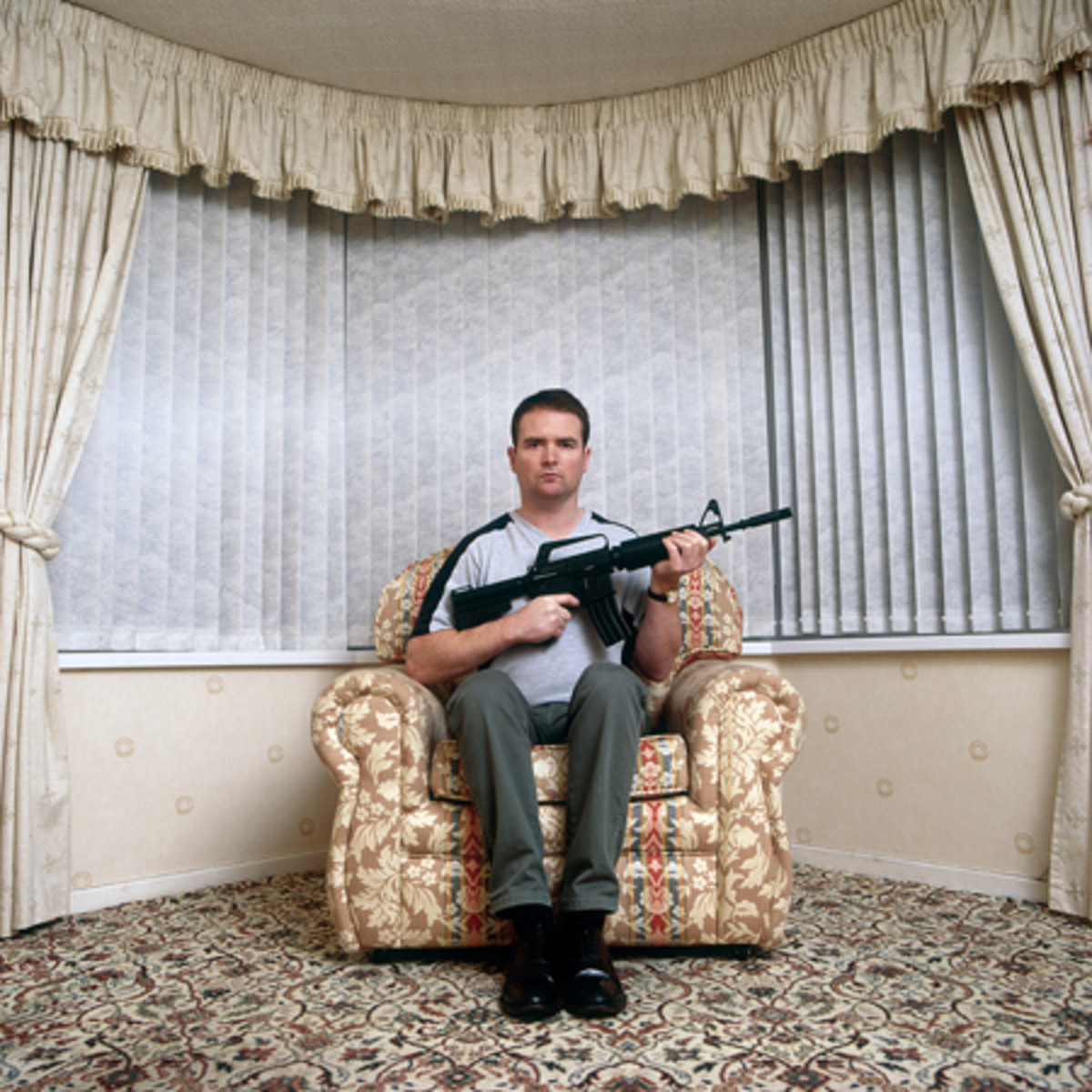 Vincent McKenna poses in his Haypark Avenue lair with a replica AR15 variant.
