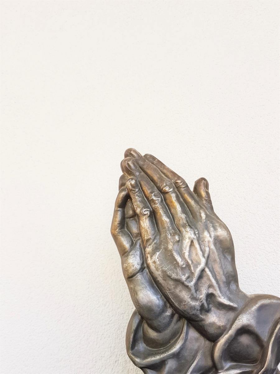 Praying hands in statue