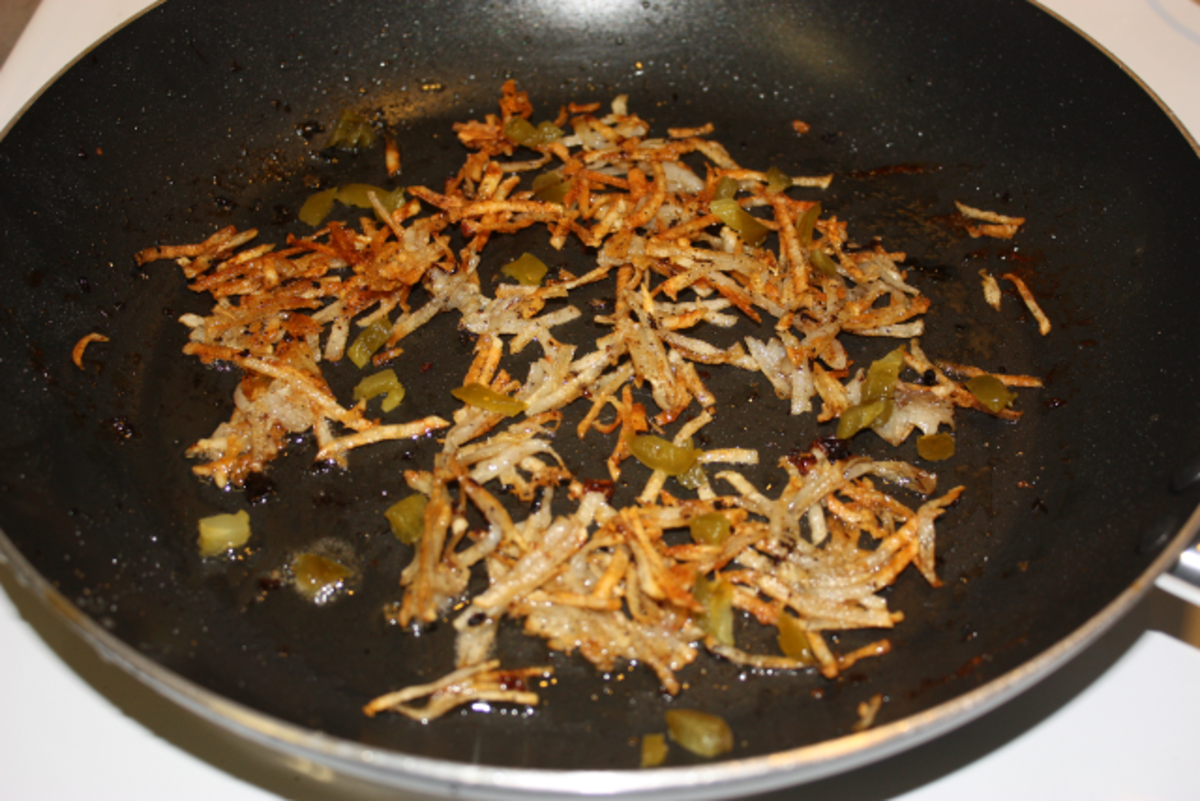 Browning the hash brown with a little jalapeno added in.