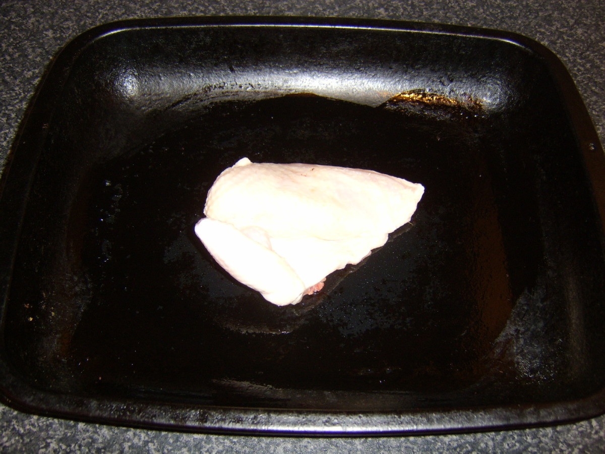 Chicken quarter on baking tray, ready for roasting