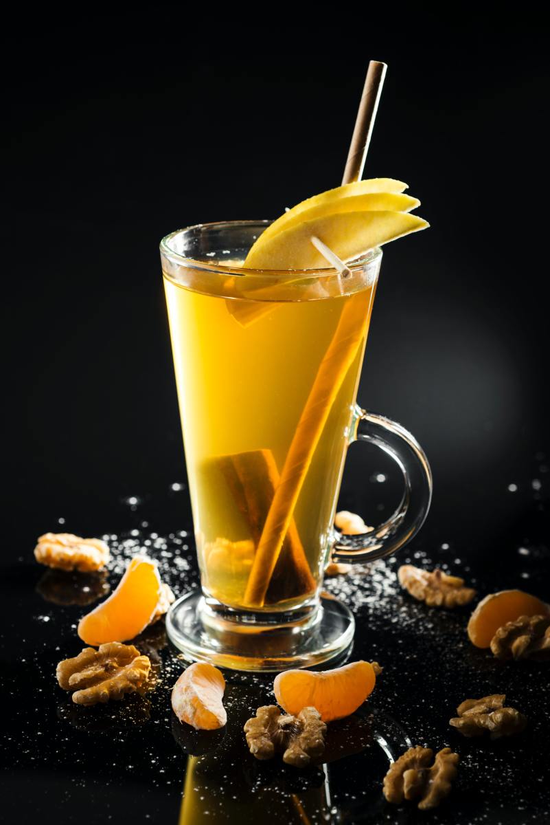 Hot toddy with cinnamon sticks and a slice of lemon
