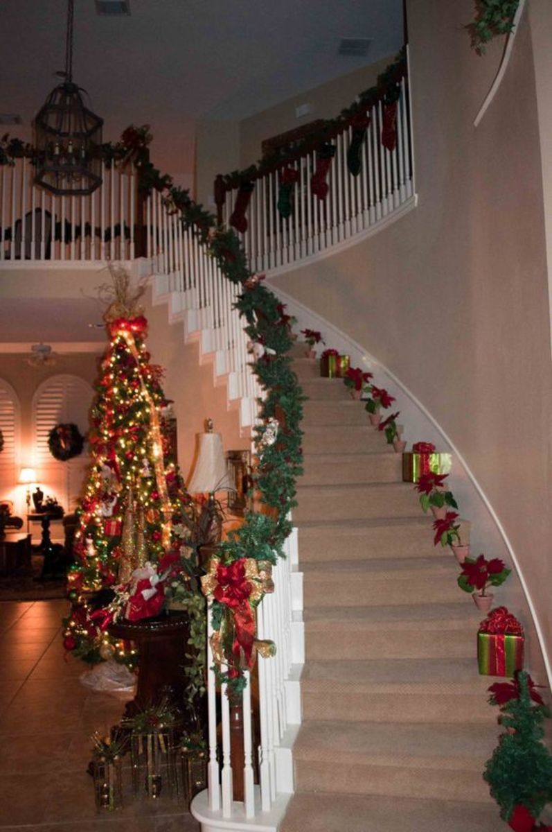 poinsettias and gifts up the staircase