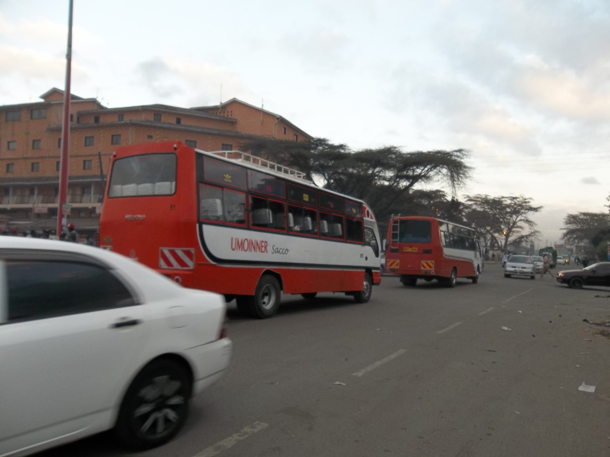 Two UMOINNER buses, members of one of the numerous franchises, rushing to Umoja estate to pick passengers