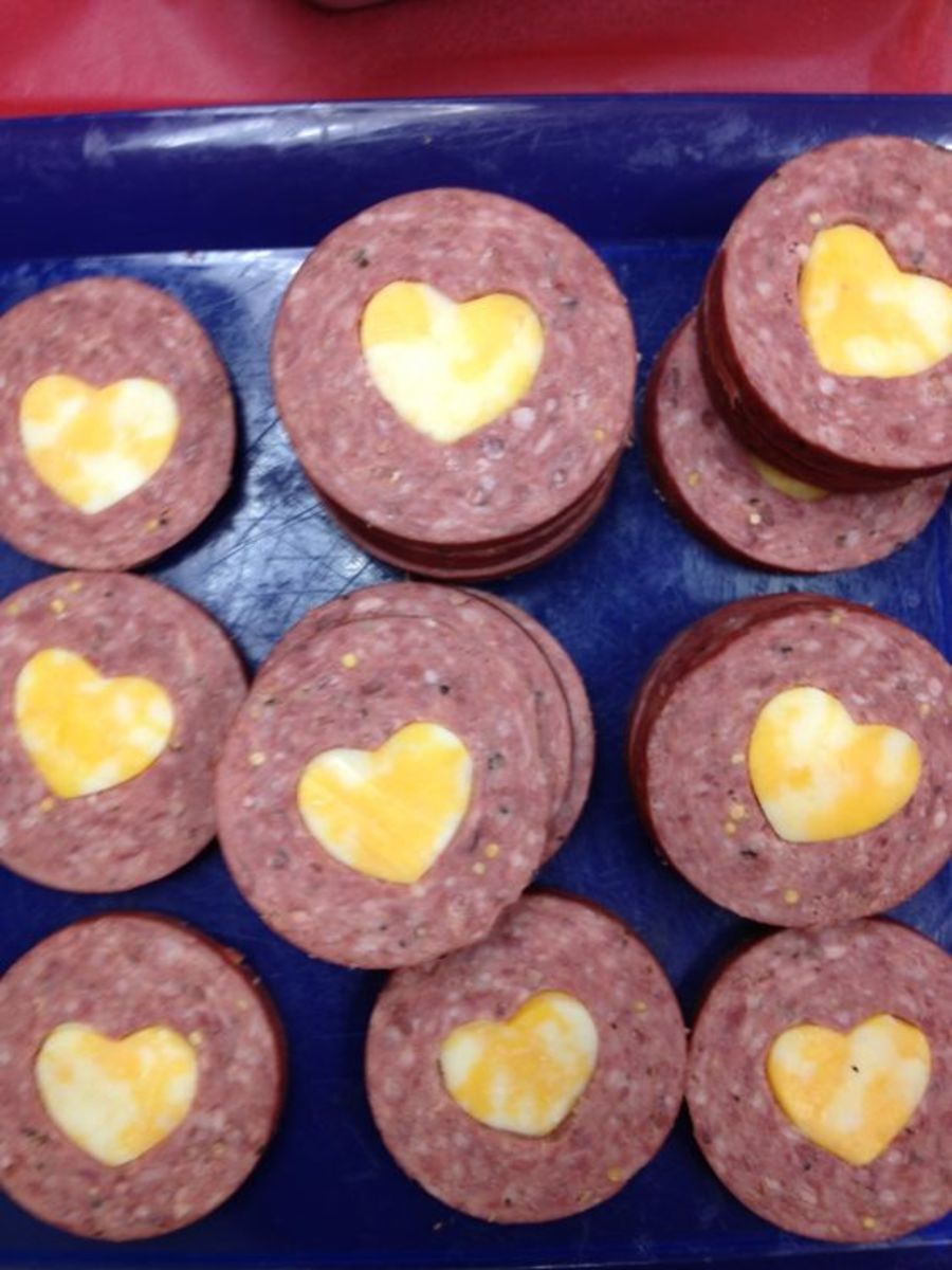 Valentine snacks: summer sausage with Colby jack cheese heart cut outs. Just use a small heart shapes cookie cutter, cut out the center of a summer sausage circle with a heart. Cut out with the same cutter a cheese heart. Pop in and serve with cracke