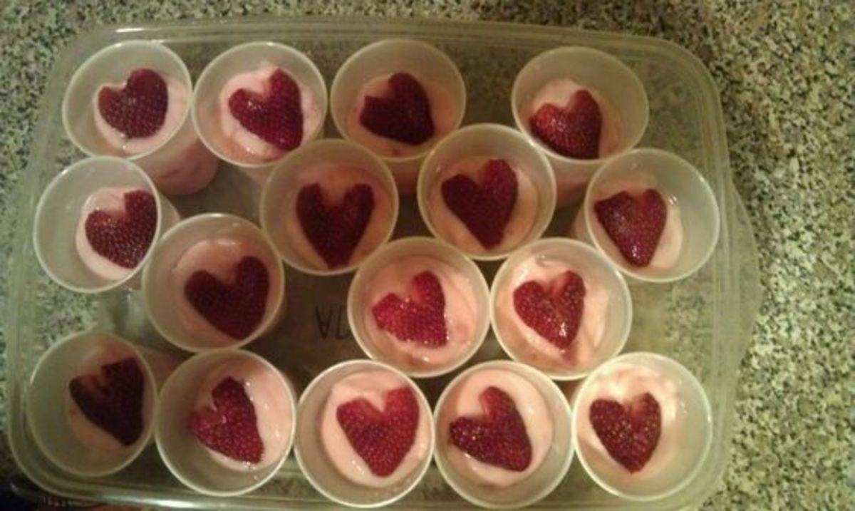 Healthy Valentine's party treat for kids....lowfat strawberry yogurt topped with a halved strawberry cut into a heart.