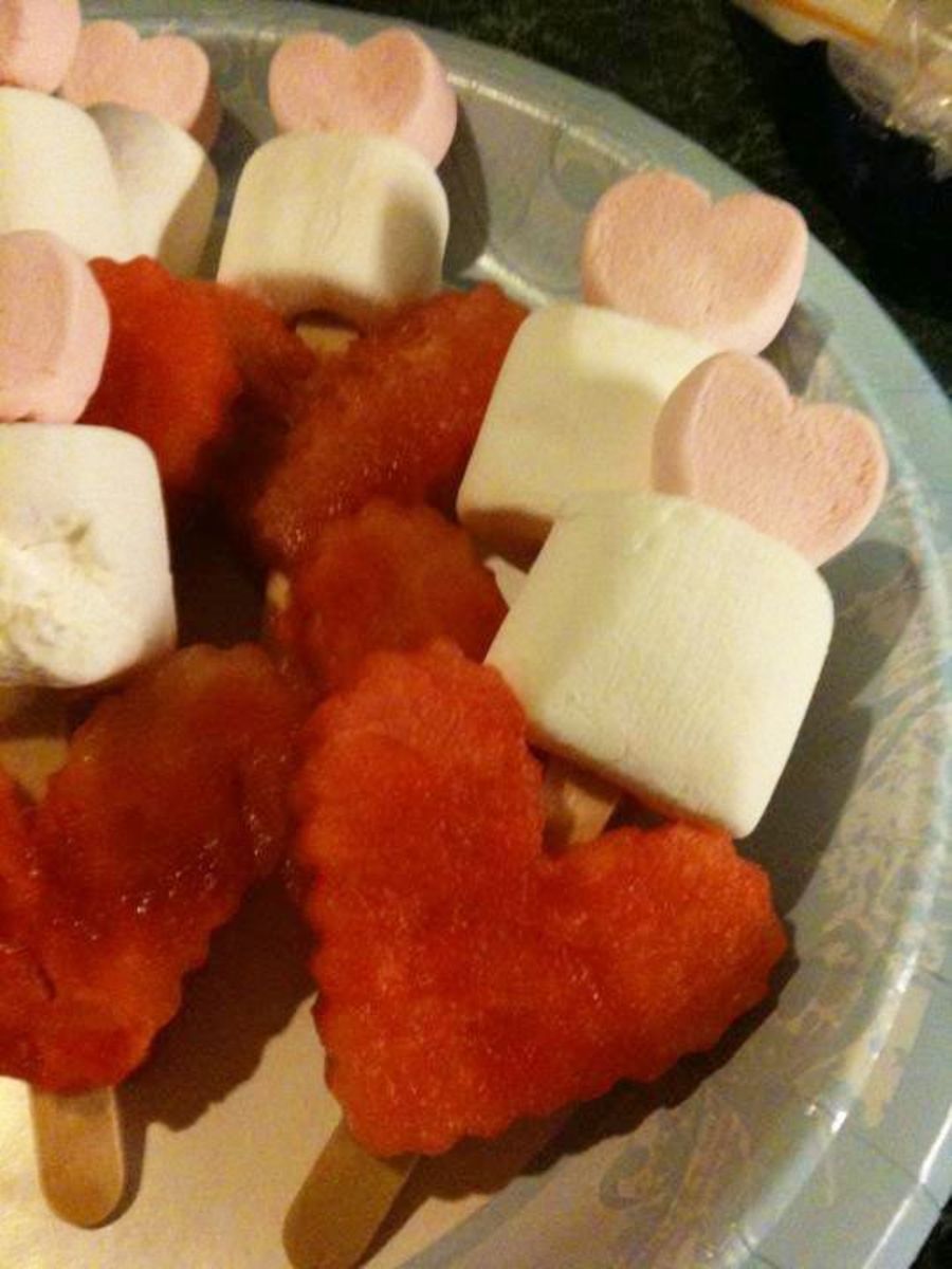 Fun snack for Valentine's party - heart shaped watermelon with both regular and heart shaped marshmallows (on craft sticks so it's kid safe)