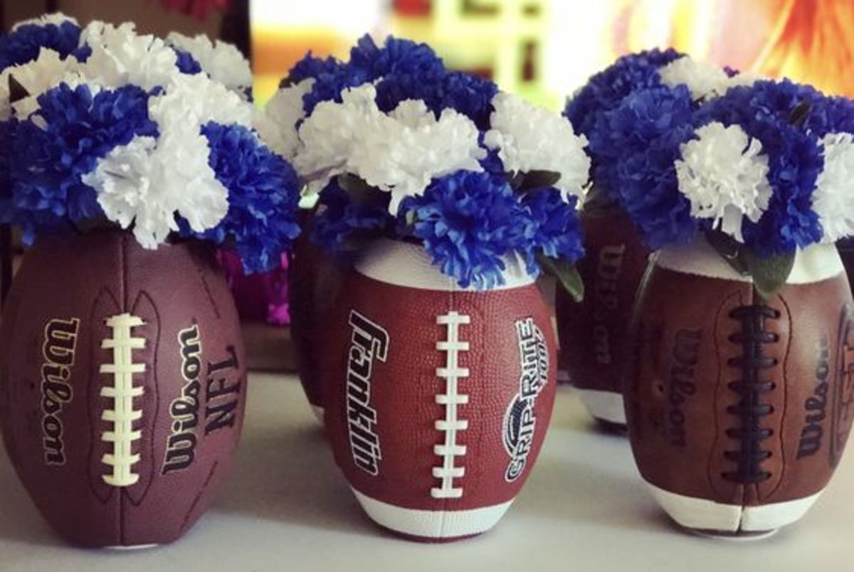 Football vases made from footballs ($4.88 Walmart footballs, or thrift store footballs. The cheaper the material, the better!) and dollar tree vases & flowers! Perfect for super bowl parties, or a football themed wedding!