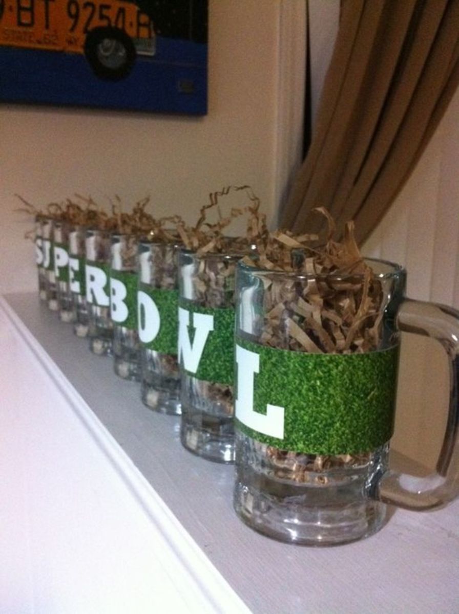 Easy $3 Superbowl Centerpiece. Use beer mugs and fill them up with gift bag fillers from the Dollar Store and print out letters to tape on the glasses.