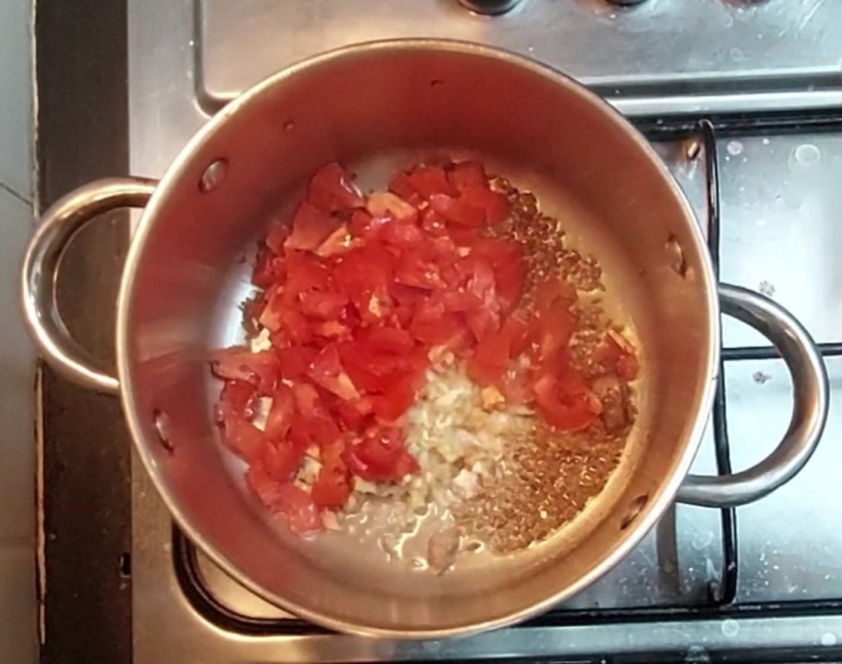 Add 2 teaspoons grated ginger and 1 cup chopped tomatoes.
