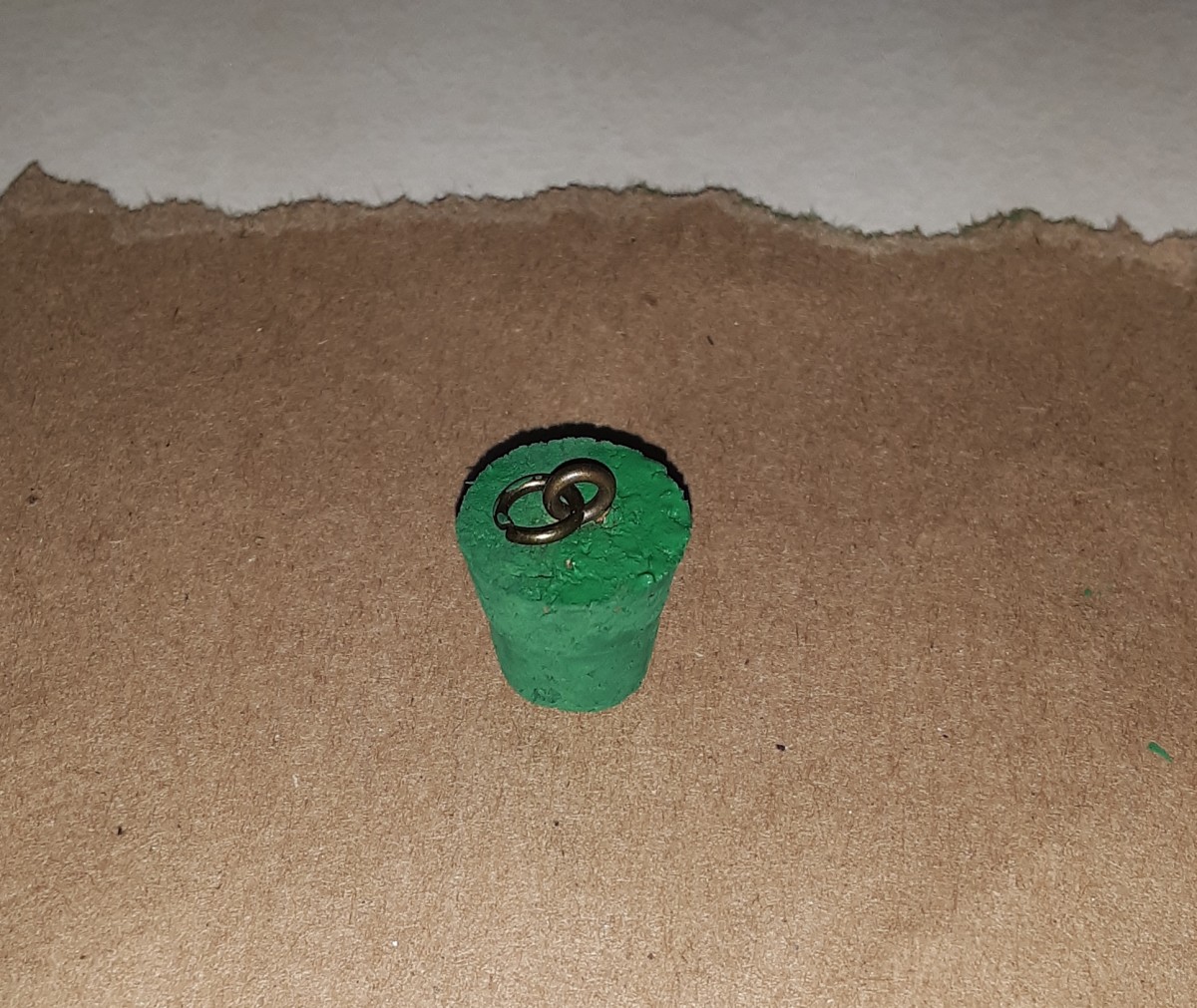 Paint cork green and let dry. Be careful not to smudge paint on metal rings.