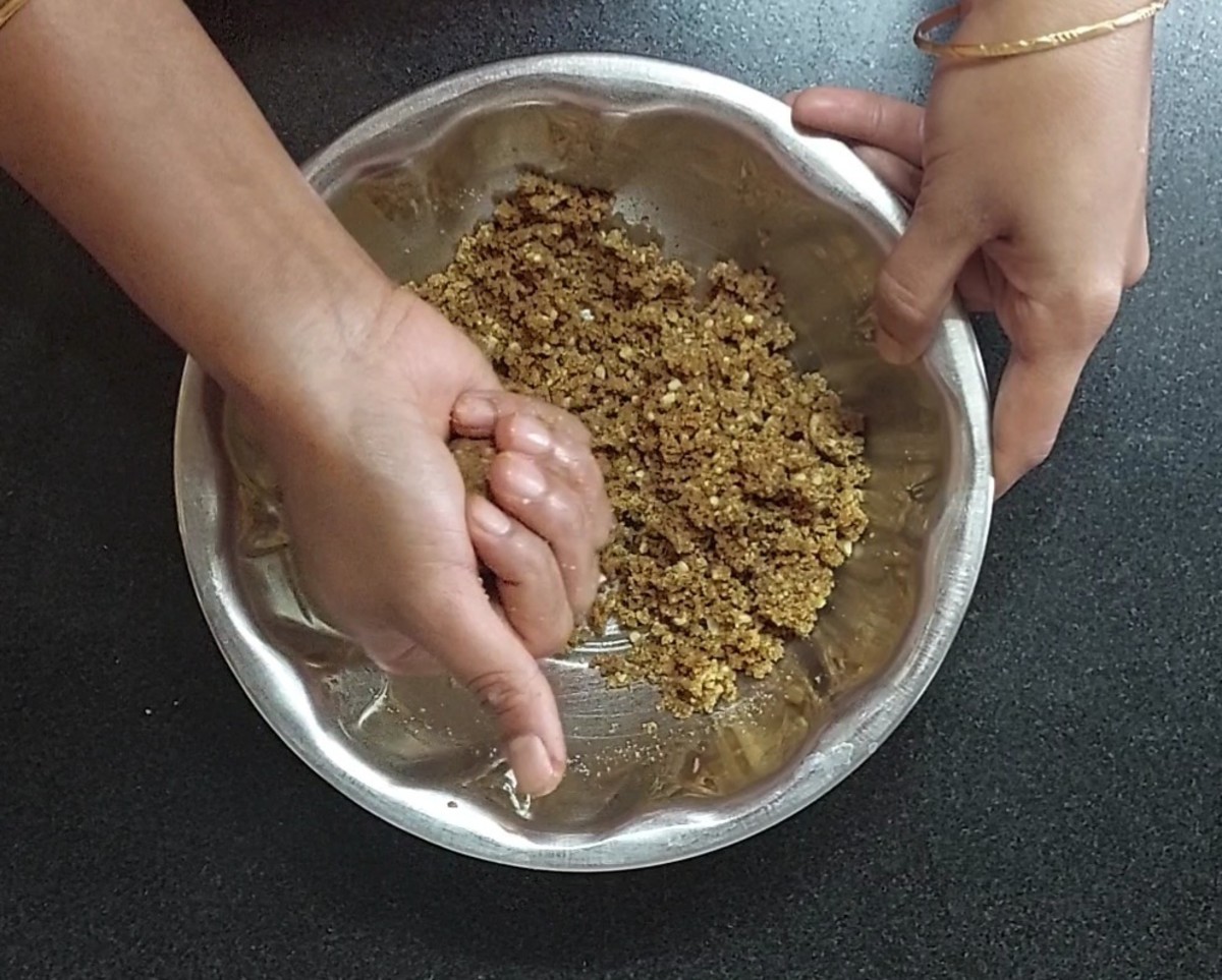 Once it is properly mixed, take a small amount of the mixture and form a round laddu in your hand.