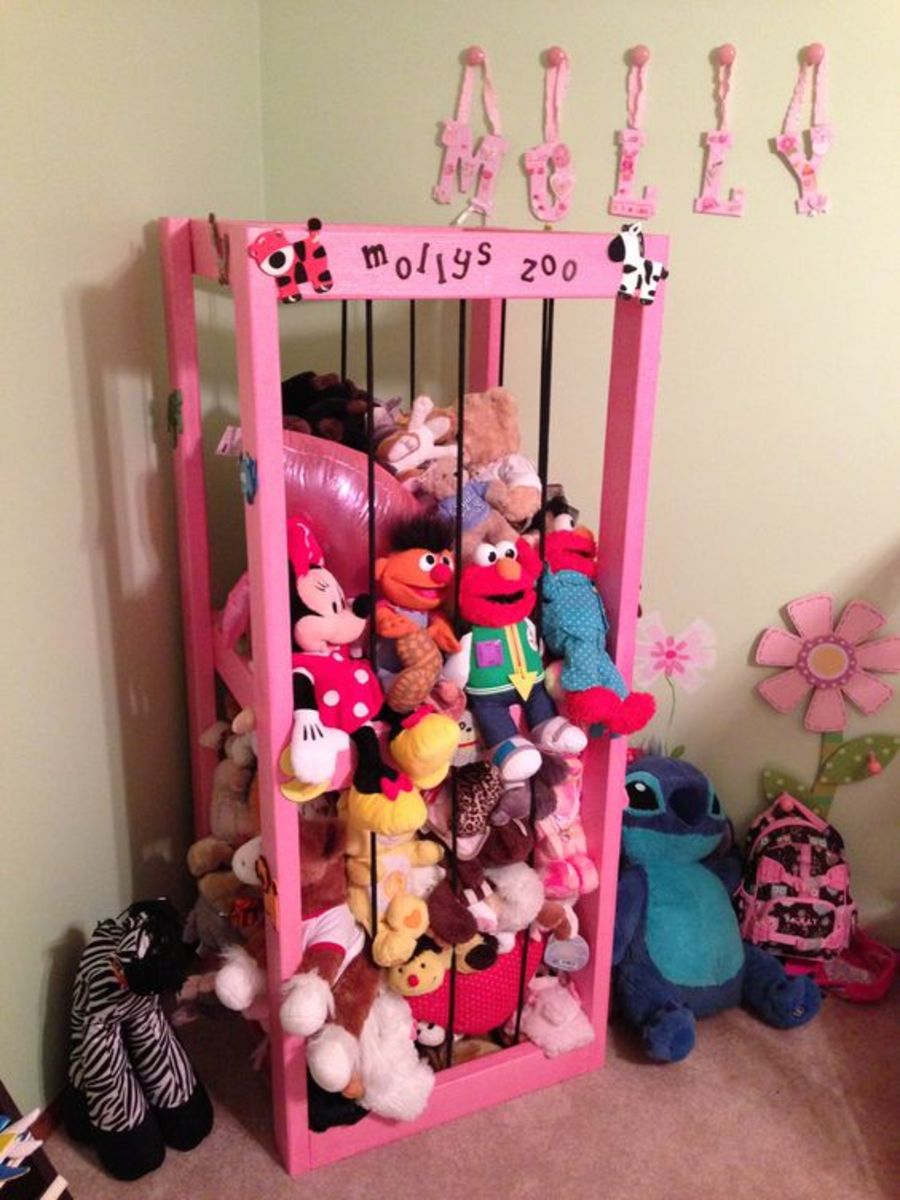 This animal cage for stuffed animals is made out of 2X4s and black bungee cord.