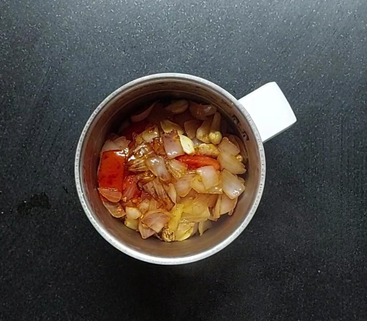 Transfer the onion-tomato mixture to the mixer jar.