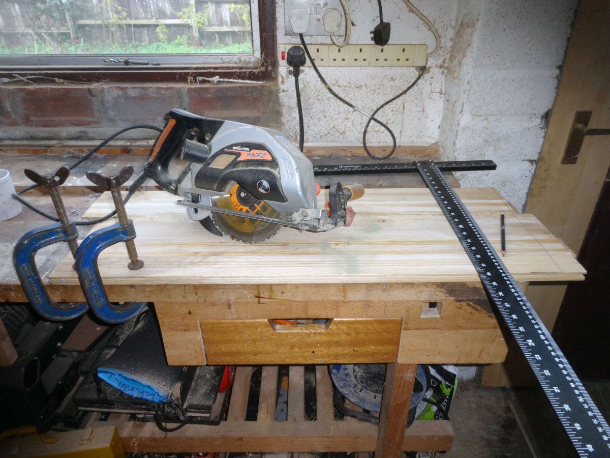 Using a T-square and pencil to mark the ends square, and then a circular saw, following the pencil line, to cut square