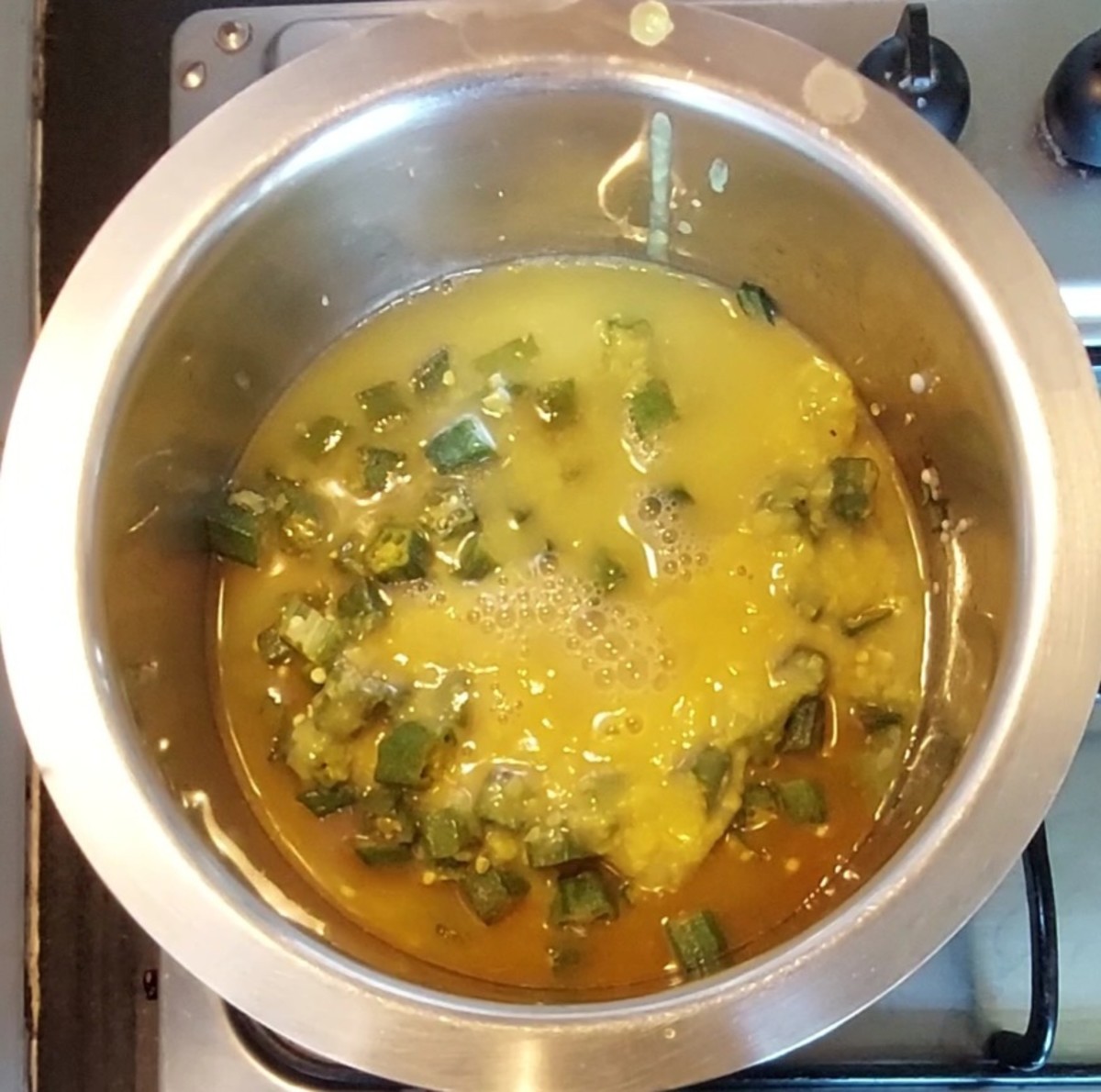 Once lady's fingers are cooked well, add cooked dal and 1 cup of water. Mix and combine well. Adjust salt and mix.