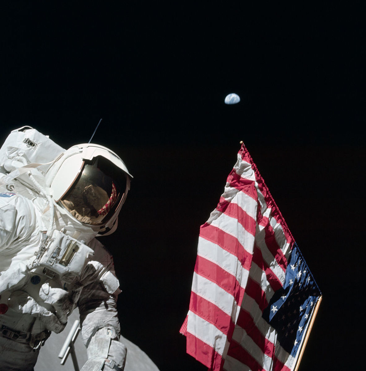 Schmitt poses by the American flag, with Earth in the background, during Apollo 17's first EVA. He was the first and only scientist to reach the moon during the Apollo Missions.