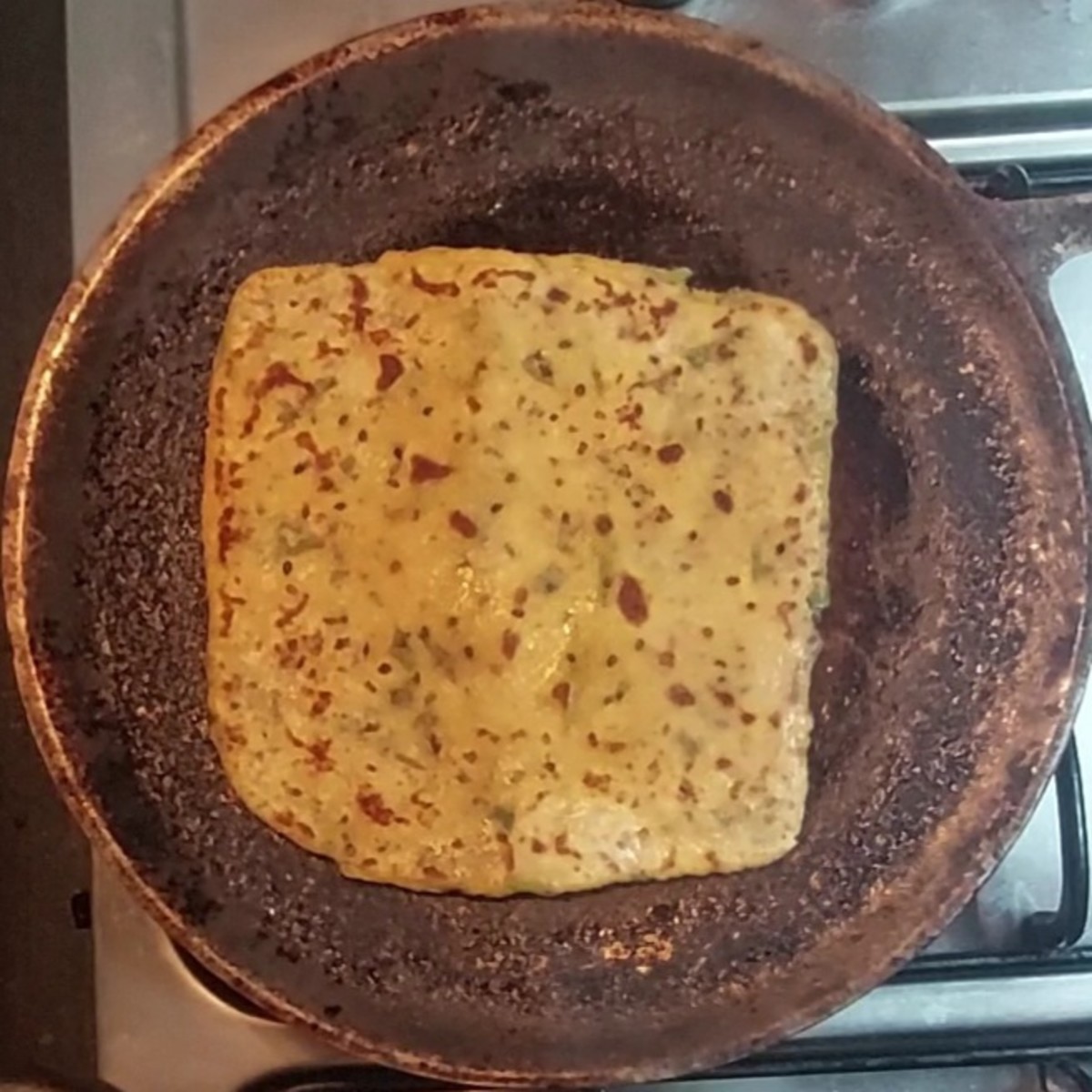 Flip and cook both sides till brown spots appear. Transfer to a plate.