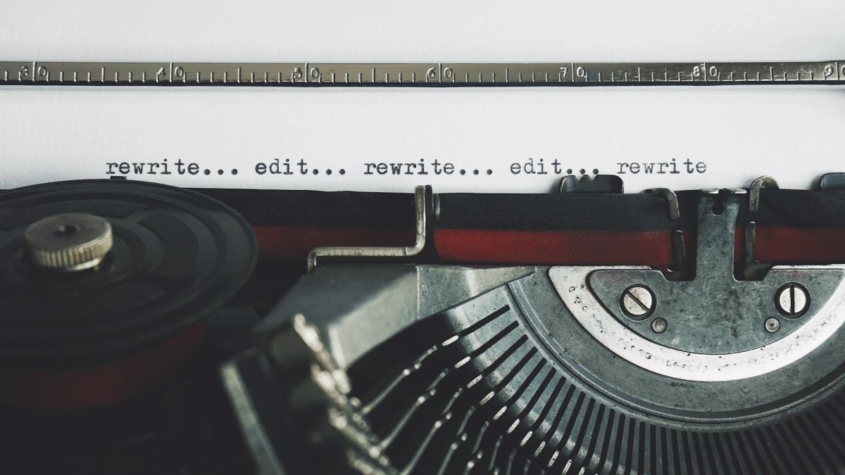 Old typewriter shows a sequence of words. Once you learn that rewriting is inevitable in all writing, you will have grown as a writer.