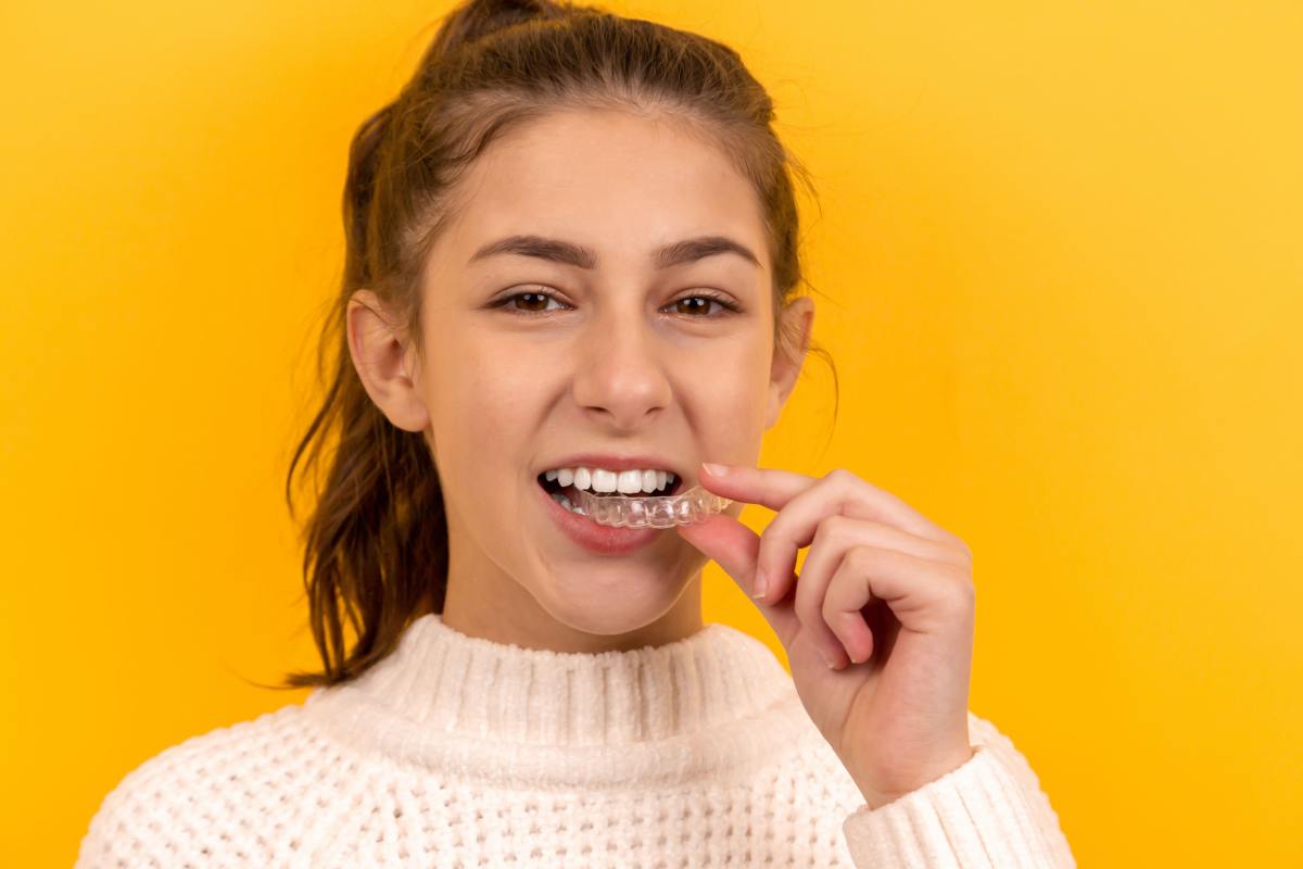 A girl wearing Invisalign