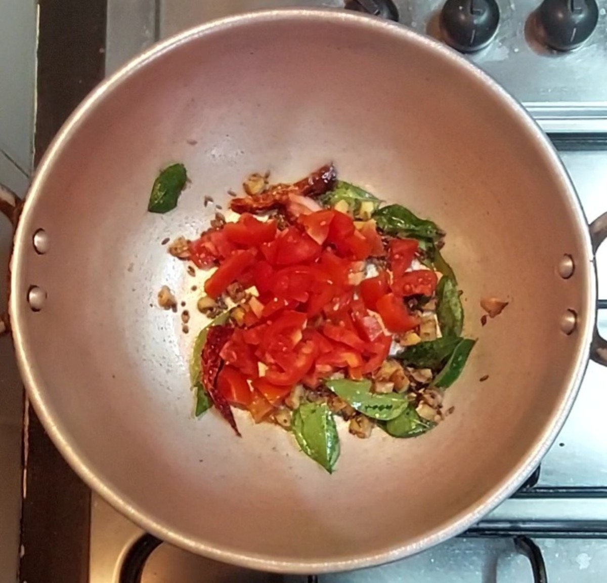 Add 1-2 chopped tomatoes, saute for 1-2 minutes.